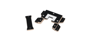 Black domino tiles with gold edges arranged to form a question mark on a white background.